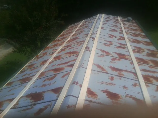 Rusted metal roof panels with new wood purlins before replacement — Storm Damage Roof Repair in Millmont by Roofing Brothers